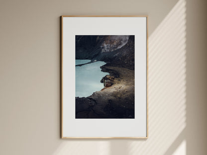 Natural oak framed fine art print of Poas volcano crater hanging on a beige living room wall