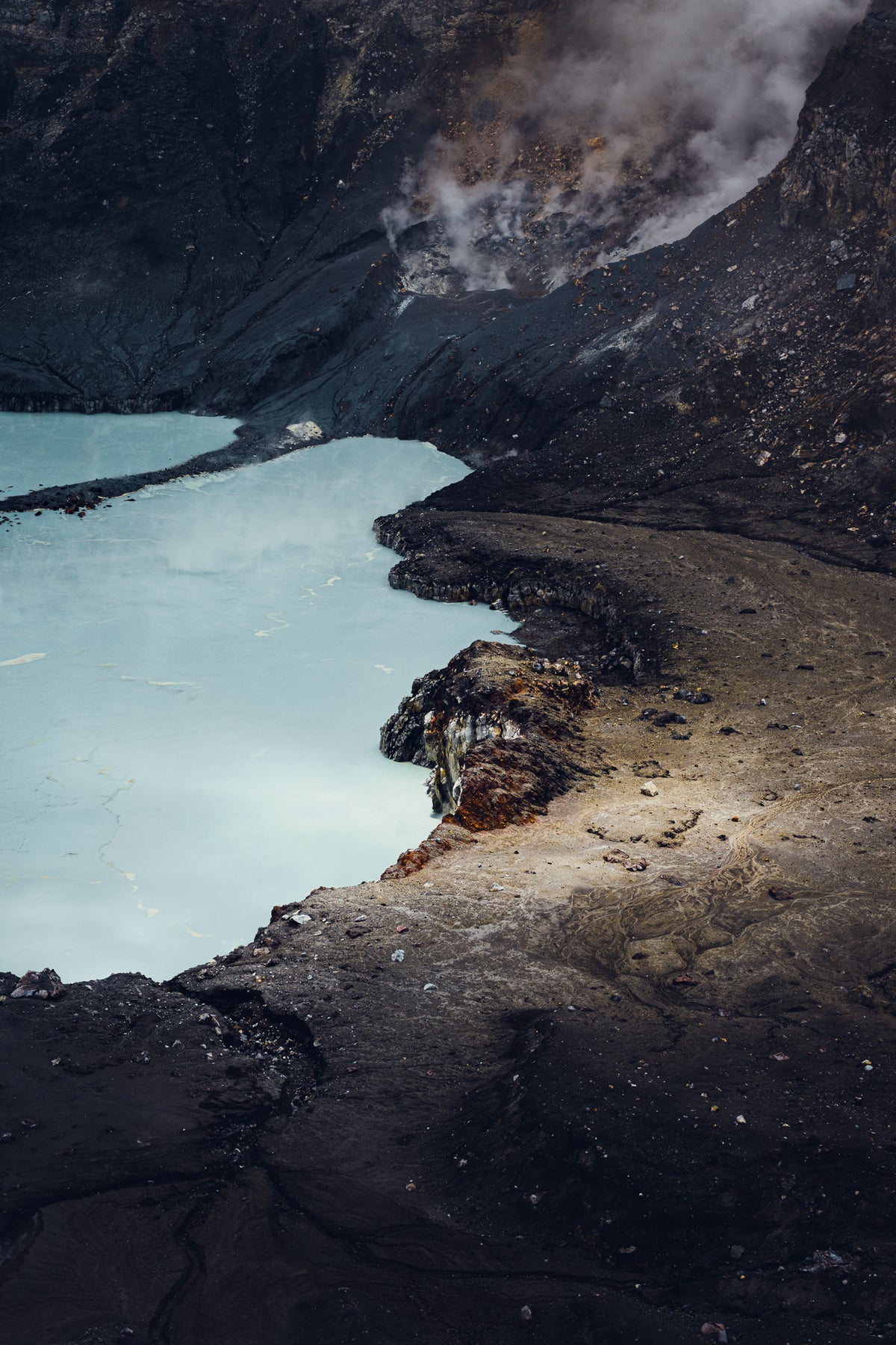 Fine art photograph of steam rising from Poas volcano turquoise crater lake in Costa Rica by Basile Tournier