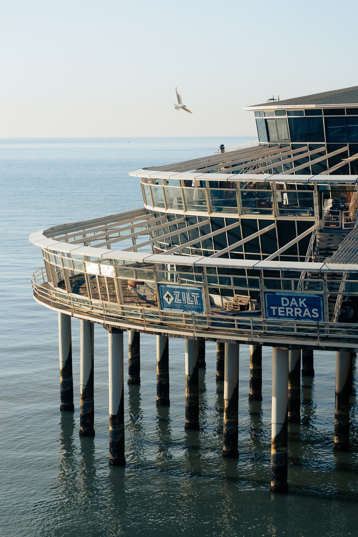 Vertical fine art architectural photograph of Scheveningen Pier over the North Sea in Netherlands by Basile Tournier